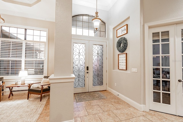 tiled entrance foyer with french doors and ornamental molding