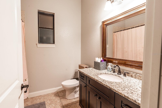 bathroom featuring toilet, vanity, and tile patterned floors