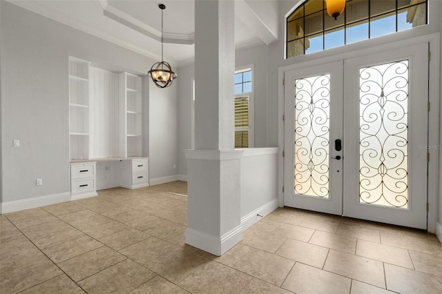 5074 Shore Side Dr, Lakeland, FL 33812 - foyer entrance with ornamental molding, light tile patterned floors, french doors, baseboards, and a chandelier