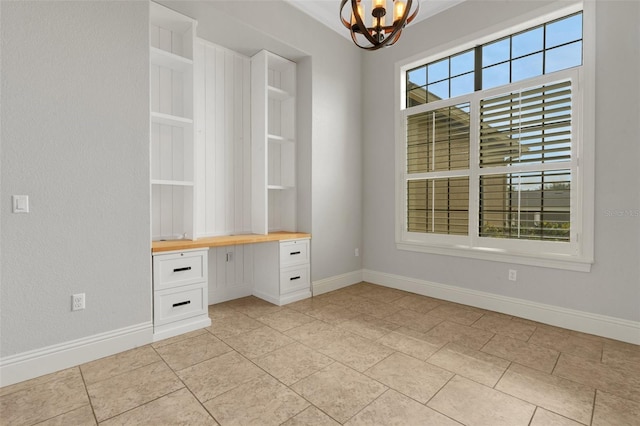 5074 Shore Side Dr, Lakeland, FL 33812 - unfurnished office featuring built in study area, a chandelier, and baseboards