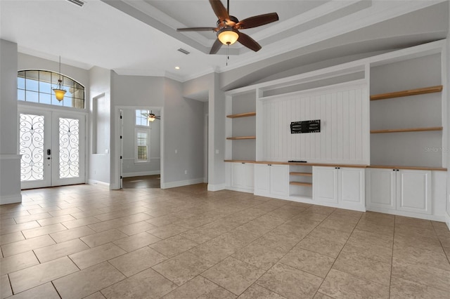 5074 Shore Side Dr, Lakeland, FL 33812 - unfurnished living room featuring ceiling fan, built in shelves, crown molding, french doors, and light tile patterned floors
