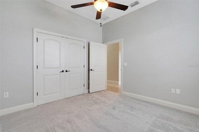 5074 Shore Side Dr, Lakeland, FL 33812 - unfurnished bedroom featuring light colored carpet, a closet, baseboards, and a ceiling fan