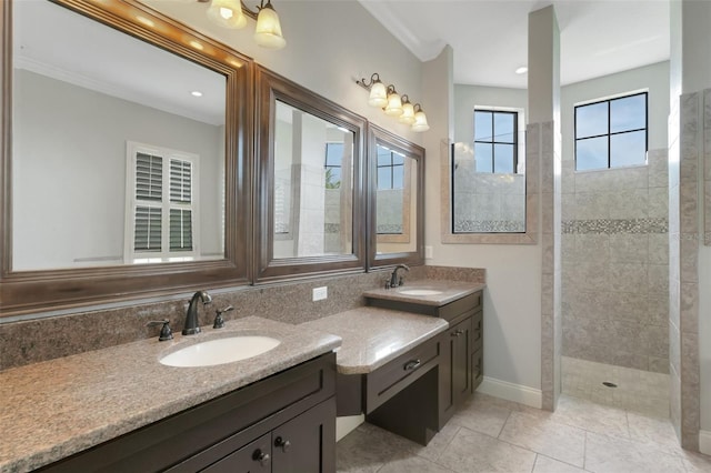 5074 Shore Side Dr, Lakeland, FL 33812 - bathroom featuring double vanity, a tile shower, baseboards, and tile patterned floors
