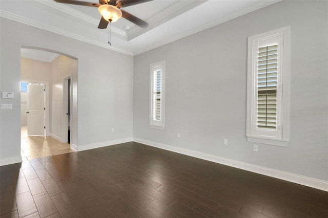 5074 Shore Side Dr, Lakeland, FL 33812 - empty room with arched walkways, a ceiling fan, healthy amount of natural light, dark wood-style flooring, and crown molding