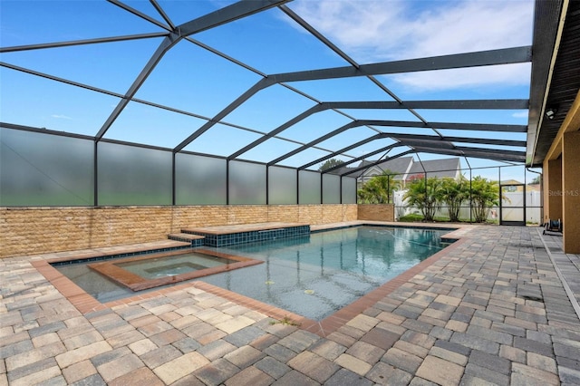 5074 Shore Side Dr, Lakeland, FL 33812 - view of swimming pool featuring a patio, glass enclosure, and a pool with connected hot tub