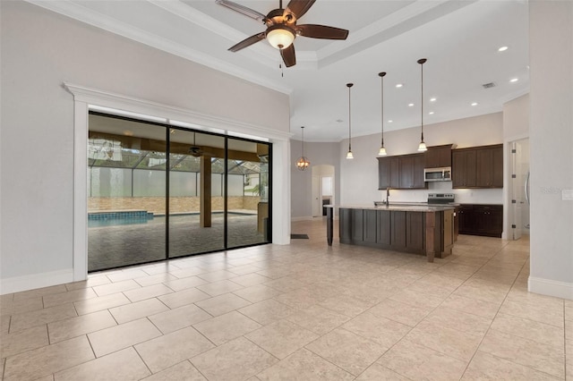 5074 Shore Side Dr, Lakeland, FL 33812 - kitchen with baseboards, dark brown cabinetry, stainless steel appliances, ceiling fan, and hanging light fixtures