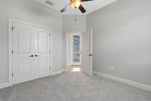 5074 Shore Side Dr, Lakeland, FL 33812 - unfurnished bedroom with carpet floors, baseboards, a closet, and ceiling fan