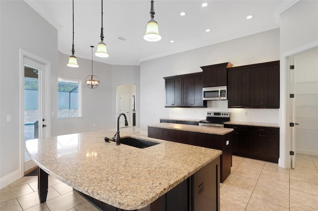 5074 Shore Side Dr, Lakeland, FL 33812 - kitchen with appliances with stainless steel finishes, a kitchen island with sink, a sink, light tile patterned floors, and arched walkways
