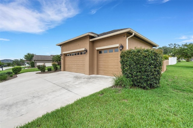 5074 Shore Side Dr, Lakeland, FL 33812 - view of side of property featuring a garage, driveway, a yard, and stucco siding