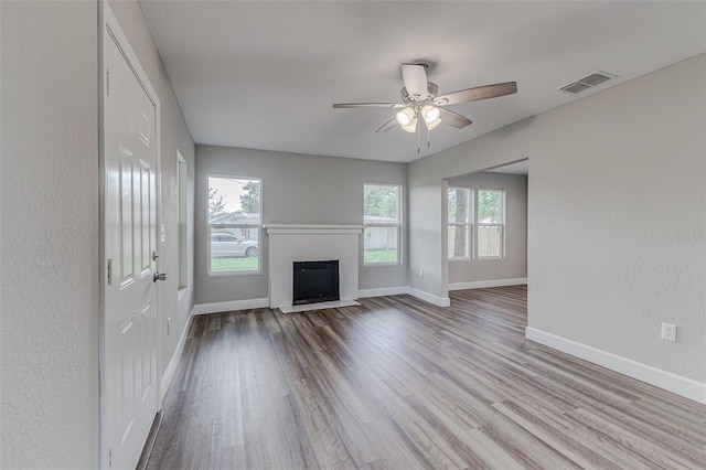 unfurnished living room with light hardwood / wood-style floors and ceiling fan