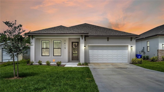 view of front of house featuring a yard and a garage