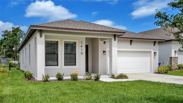 view of front of home with a front yard and a garage