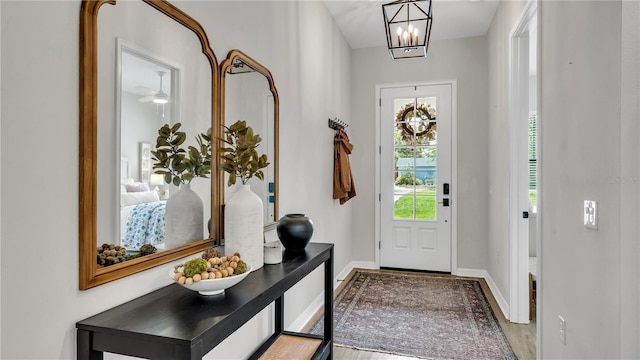 entrance foyer with hardwood / wood-style flooring and an inviting chandelier