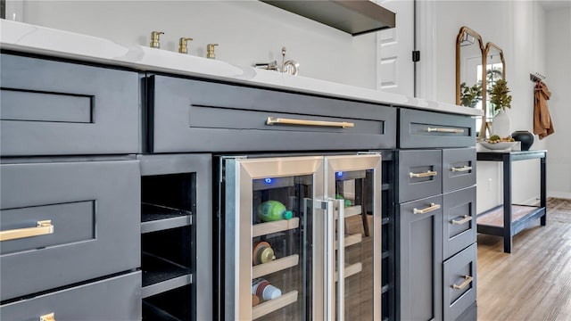 room details featuring wine cooler and hardwood / wood-style flooring