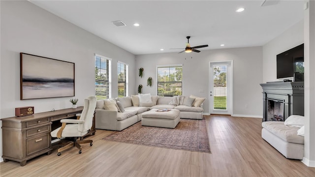 living room featuring light wood-type flooring and ceiling fan