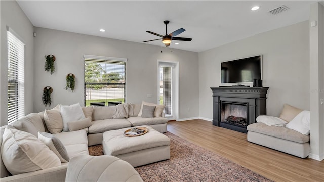 living room featuring hardwood / wood-style floors and ceiling fan