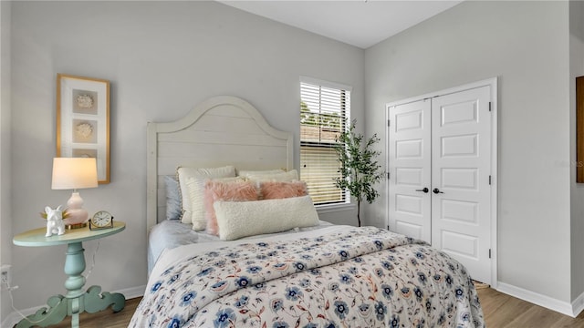 bedroom with light hardwood / wood-style flooring and a closet