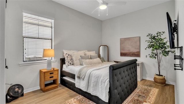 bedroom with light hardwood / wood-style floors and ceiling fan