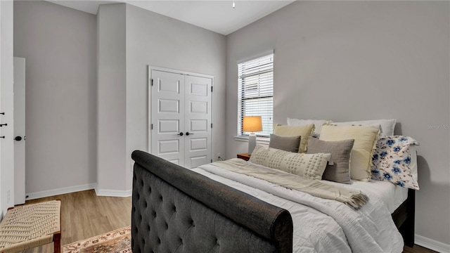 bedroom featuring wood-type flooring and a closet