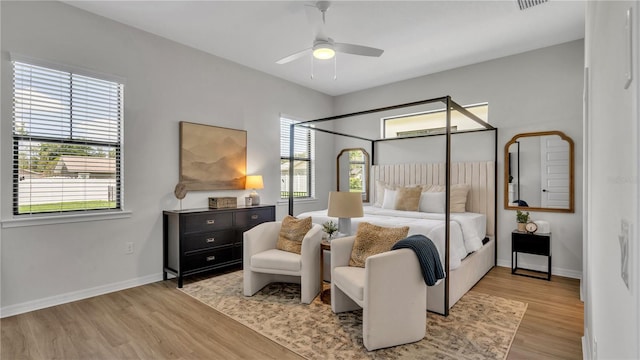 bedroom with light hardwood / wood-style floors and ceiling fan