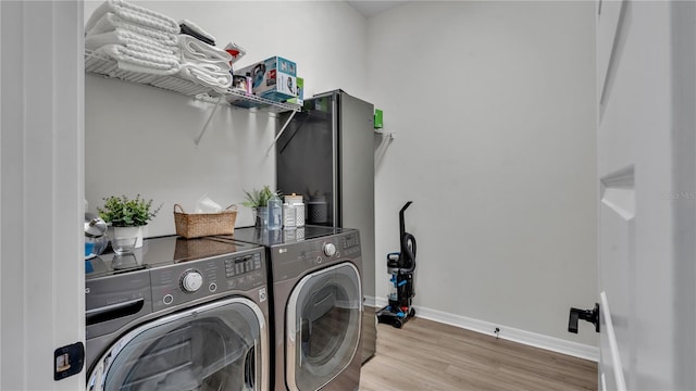 laundry room with hardwood / wood-style floors and separate washer and dryer