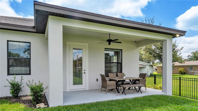 exterior space featuring a yard, ceiling fan, and a patio area