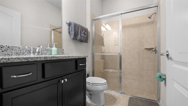 bathroom with toilet, an enclosed shower, vanity, and tile patterned flooring