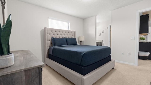 carpeted bedroom with ensuite bath