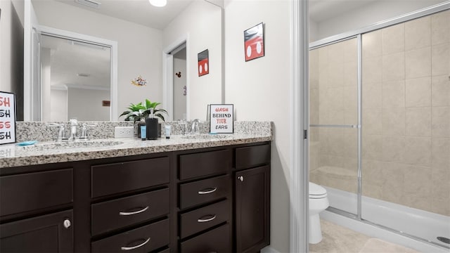 bathroom with toilet, vanity, tile patterned flooring, and walk in shower