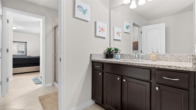 bathroom featuring tile patterned flooring, vanity, and a shower with shower door