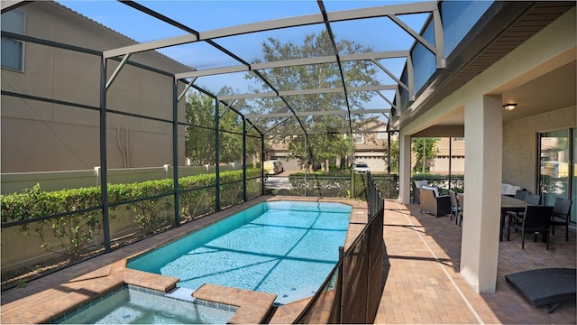 view of swimming pool featuring an in ground hot tub, glass enclosure, and a patio