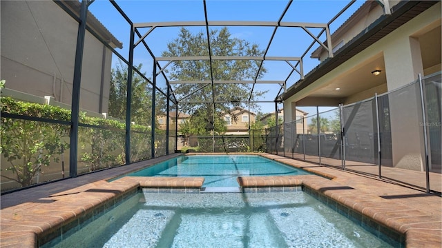 view of pool with a lanai, an in ground hot tub, and a patio area