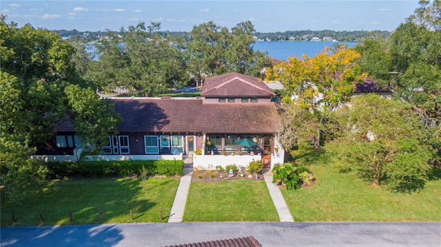 view of front of house featuring a front yard and a water view