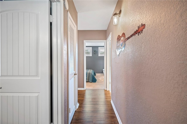 corridor featuring dark wood-type flooring