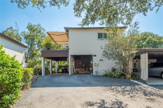view of front of home with aphalt driveway and stucco siding