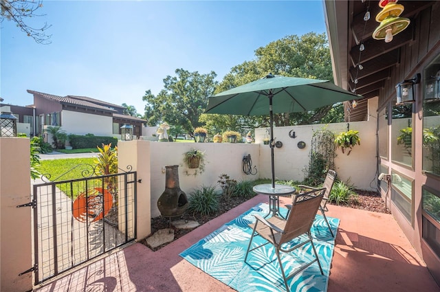 view of patio / terrace with a fenced backyard and a gate