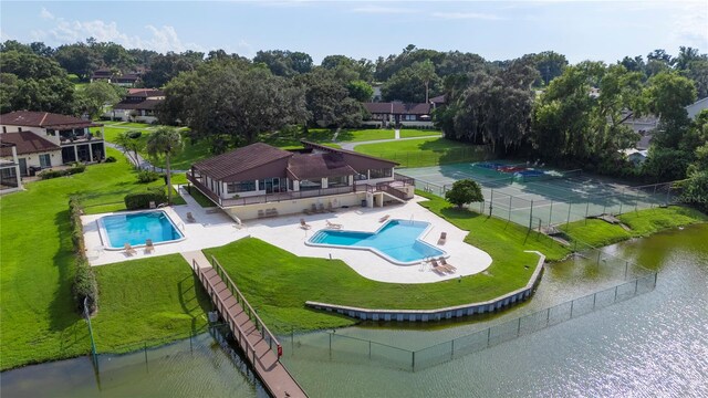 view of swimming pool featuring a patio area and a water view