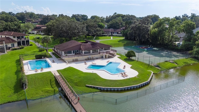 pool with a water view and fence