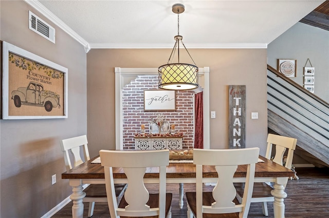 dining room with hardwood / wood-style flooring and ornamental molding