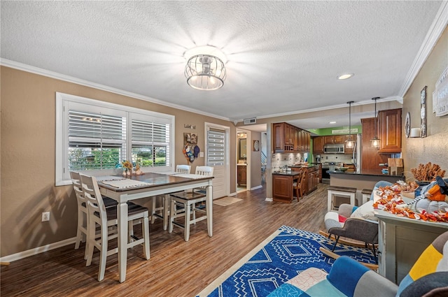 dining room with dark hardwood / wood-style flooring, crown molding, and a textured ceiling