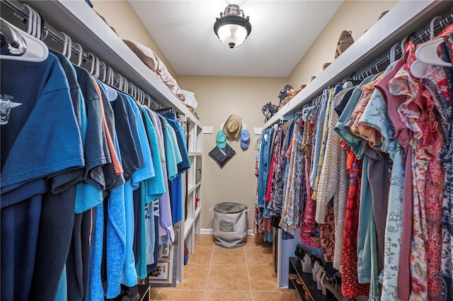 walk in closet with light tile patterned flooring