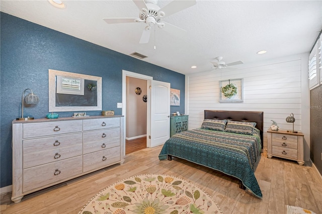 bedroom with ceiling fan and light wood-type flooring