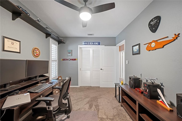 office space featuring ceiling fan and light colored carpet