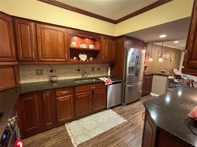 kitchen featuring sink, crown molding, appliances with stainless steel finishes, hardwood / wood-style flooring, and decorative backsplash