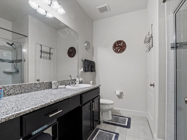 bathroom featuring tile patterned flooring, vanity, toilet, and walk in shower