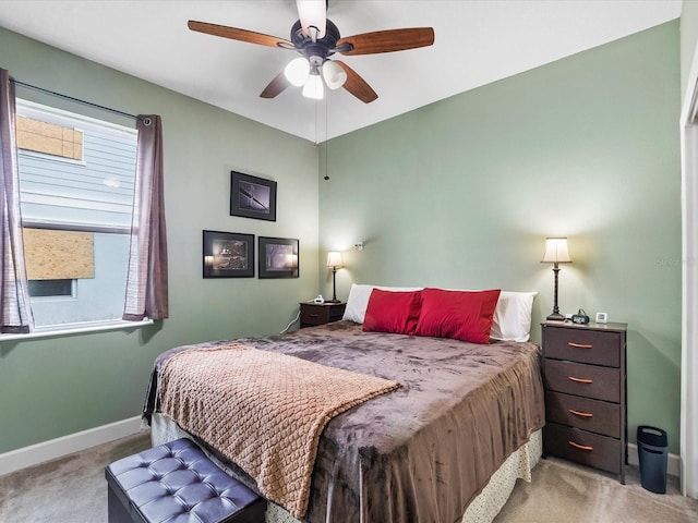 carpeted bedroom with multiple windows and ceiling fan