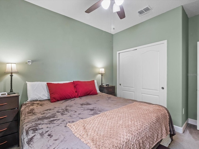 bedroom featuring ceiling fan, a closet, and light carpet