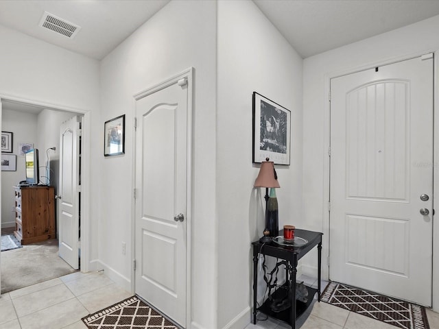 entryway with light tile patterned floors