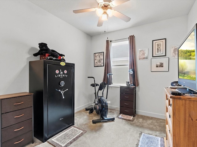 exercise area featuring light carpet and ceiling fan