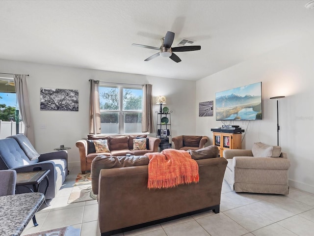 living room with ceiling fan and light tile patterned flooring